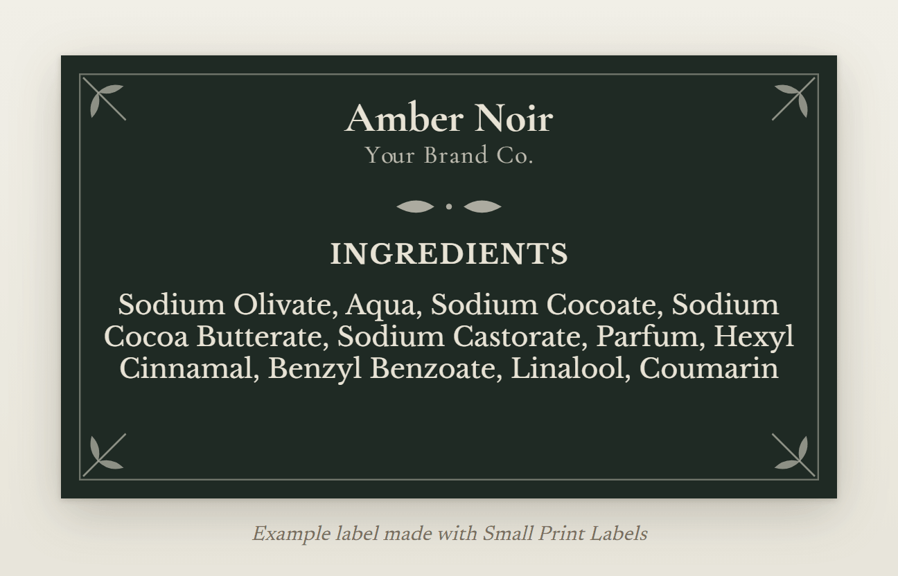 Example dark soap label, cream lettering on deep green with botanical corners: Amber Noir soap and its ingredient list with four fragrance allergens, 70 × 40 mm