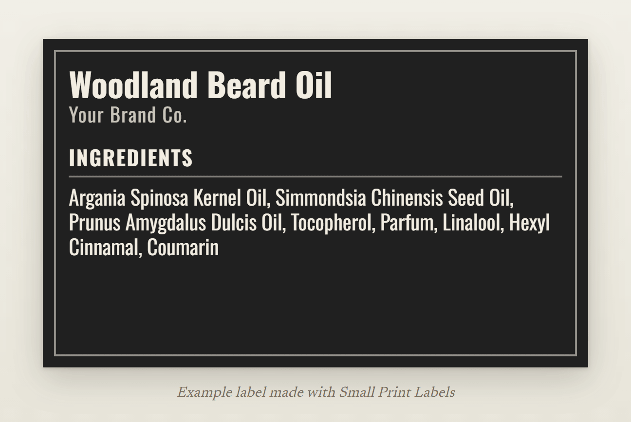 Example beard oil label, cream lettering on black with a thin frame: Woodland Beard Oil and its INCI list with three fragrance allergens, 63 × 38 mm