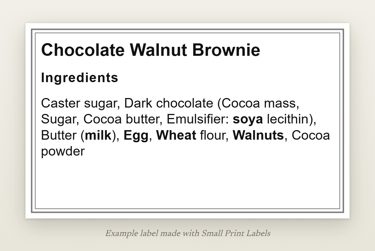 Example Natasha's Law label for a chocolate walnut brownie: the ingredient list with soya, milk, egg, wheat and walnuts in bold, 63 × 38 mm