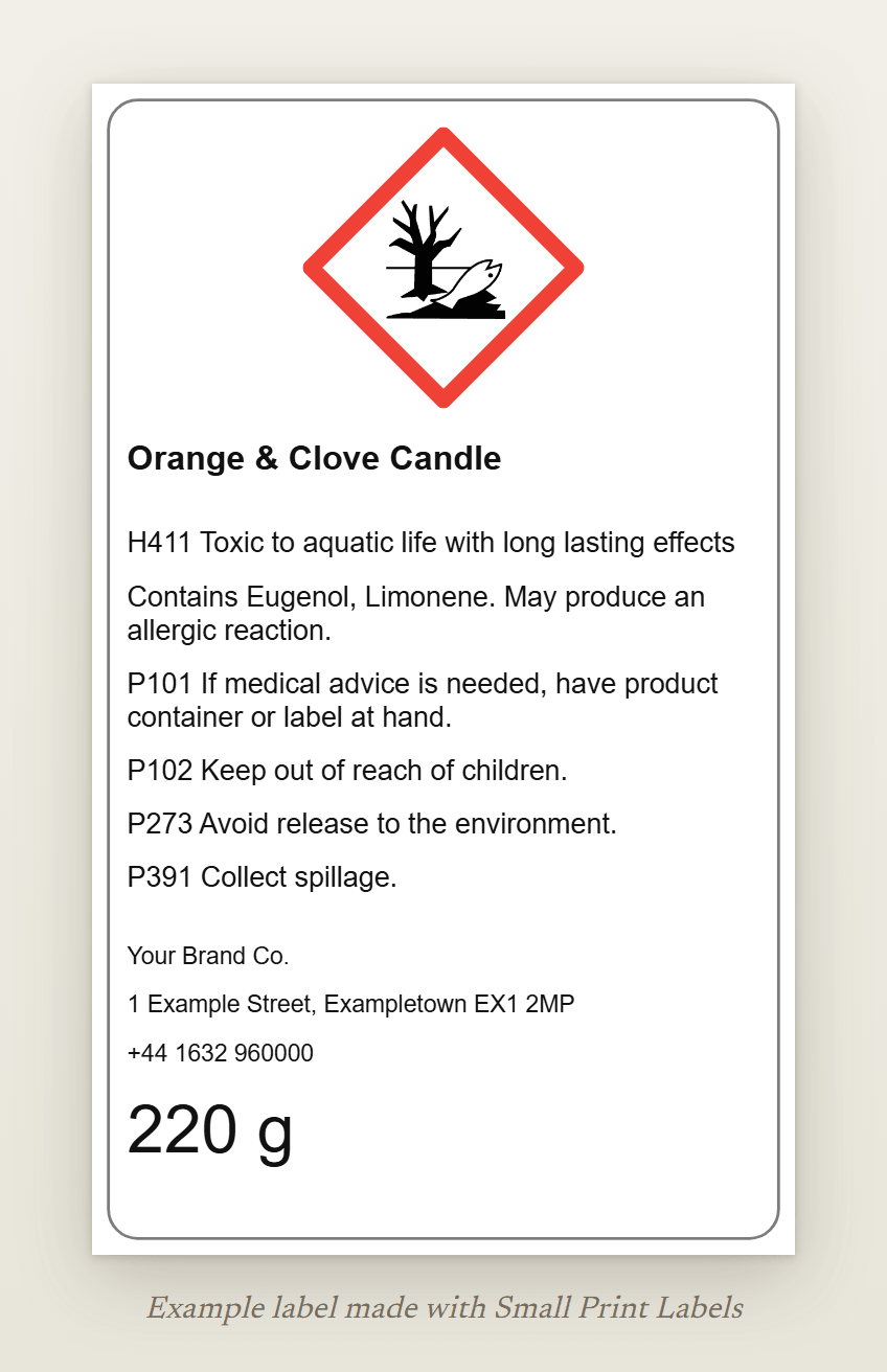 Example UK candle label with the GHS09 environment pictogram: Orange & Clove Candle, H411, the EUH208 line naming eugenol and limonene, four precautionary statements and a UK supplier, 60 × 100 mm