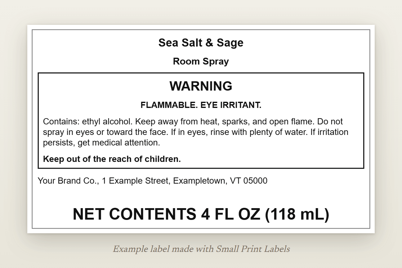 Example US room spray label: Sea Salt & Sage Room Spray, a boxed warning with WARNING, FLAMMABLE and EYE IRRITANT, Contains: ethyl alcohol, precautions, first aid, the maker's name and address, and NET CONTENTS 4 FL OZ (118 mL) at the bottom, 100 × 60 mm